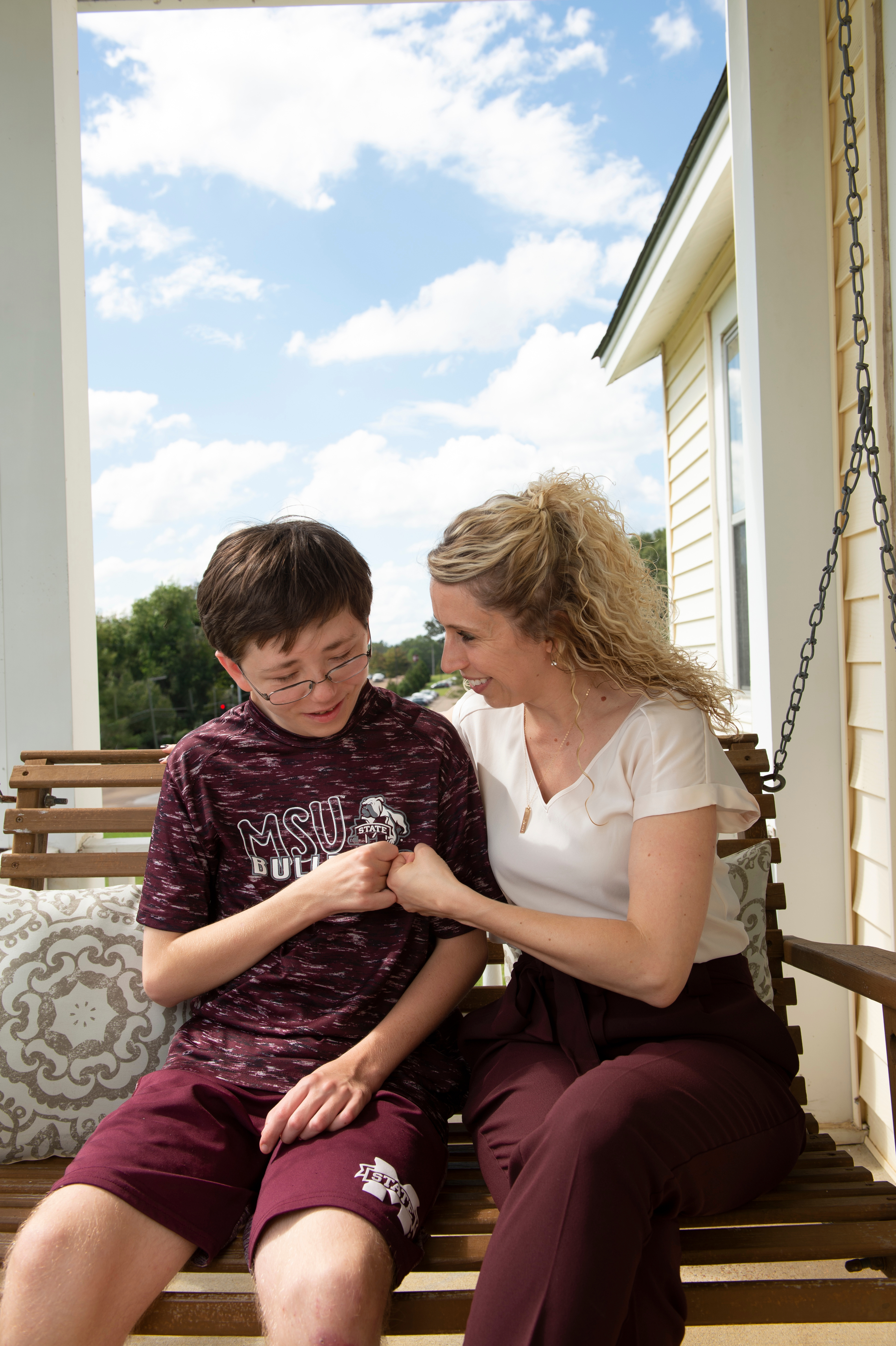 Kasee Stratton-Gadke, co-director of the Autism and Developmental Disabilities Clinic at Mississippi State, talks with an adolescent whose family has benefited from the services there.